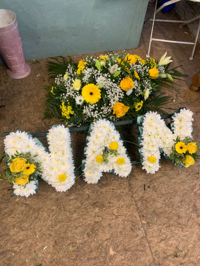 Yellow & White Letter Tribute - Personalised white and yellow letter tribute with vibrant floral accents, handcrafted to spell a name, word or message for funerals and memorials.