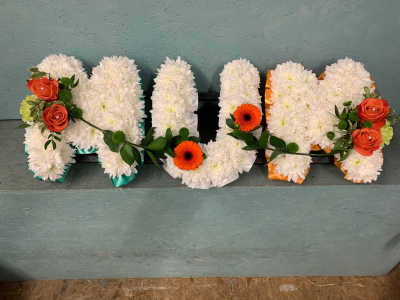 Orange Mum Letter Tribute - Orange and white Mum letter tribute handcrafted with vibrant detailing, creating a loving and meaningful tribute for funerals and memorials.
